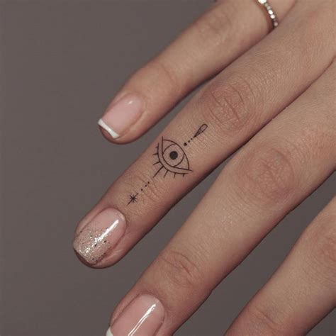 The triangle tattoo with the evil eye is a popular design that people believe will keep away bad luck from their prized possessions. . Evil eye tattoo finger